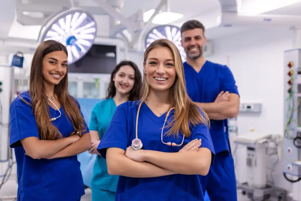 Medical team smiling in hospital operating room.