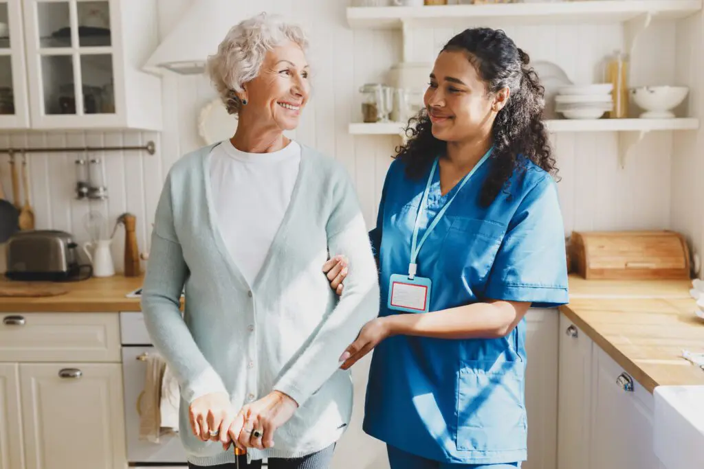 Elderly woman assisted by a healthcare worker.
