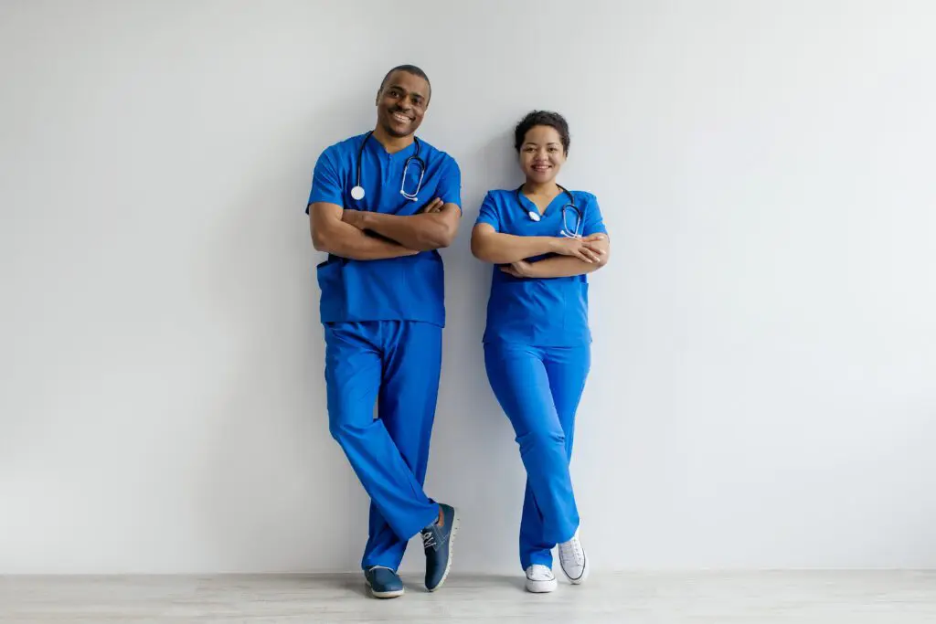 Two healthcare professionals in blue scrubs.